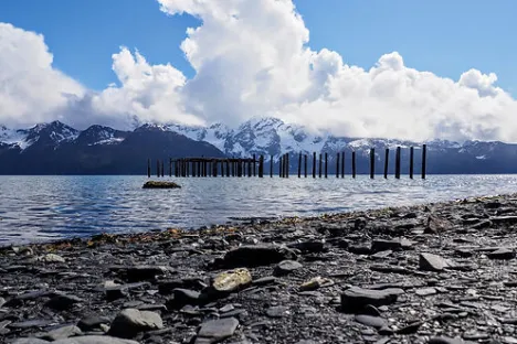 a rocky beach next to a body of water
