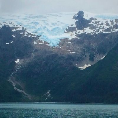 a view of water and a mountain in the background