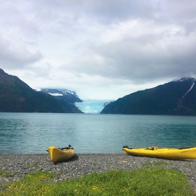 a small boat in a body of water with a mountain in the background