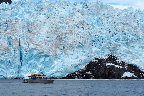 a large body of water with a mountain in the background