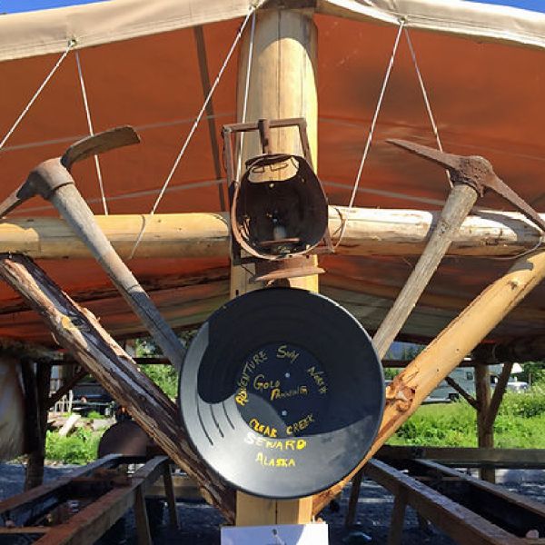 a clock sits at the top of a wooden boat