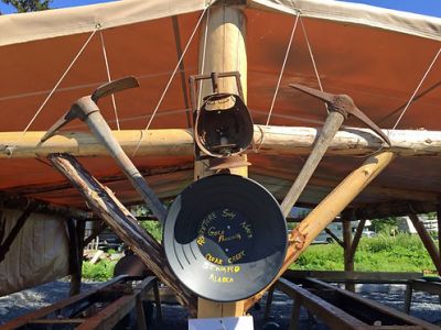 a clock sits at the top of a wooden boat