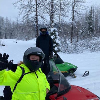 a couple of people that are standing in the snow