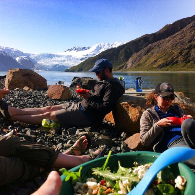 a group of people sitting on top of a mountain