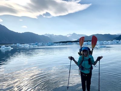 a person standing next to a body of water