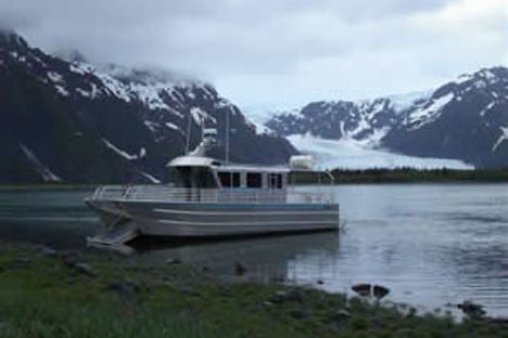a small boat in a body of water with a mountain in the background