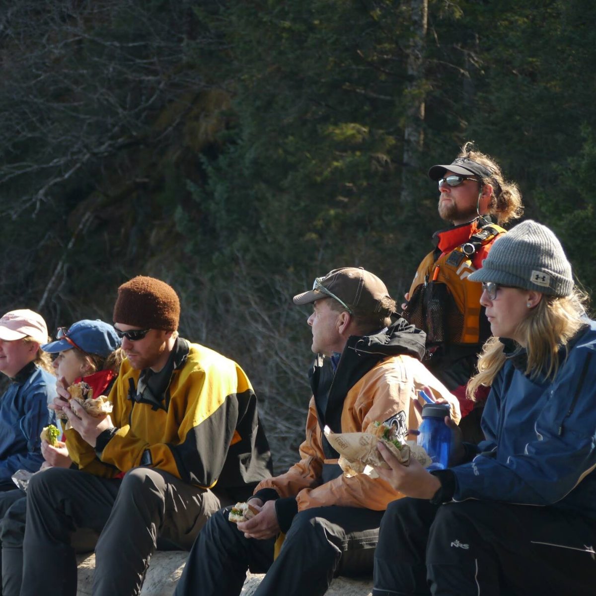 a group of people sitting on a bench
