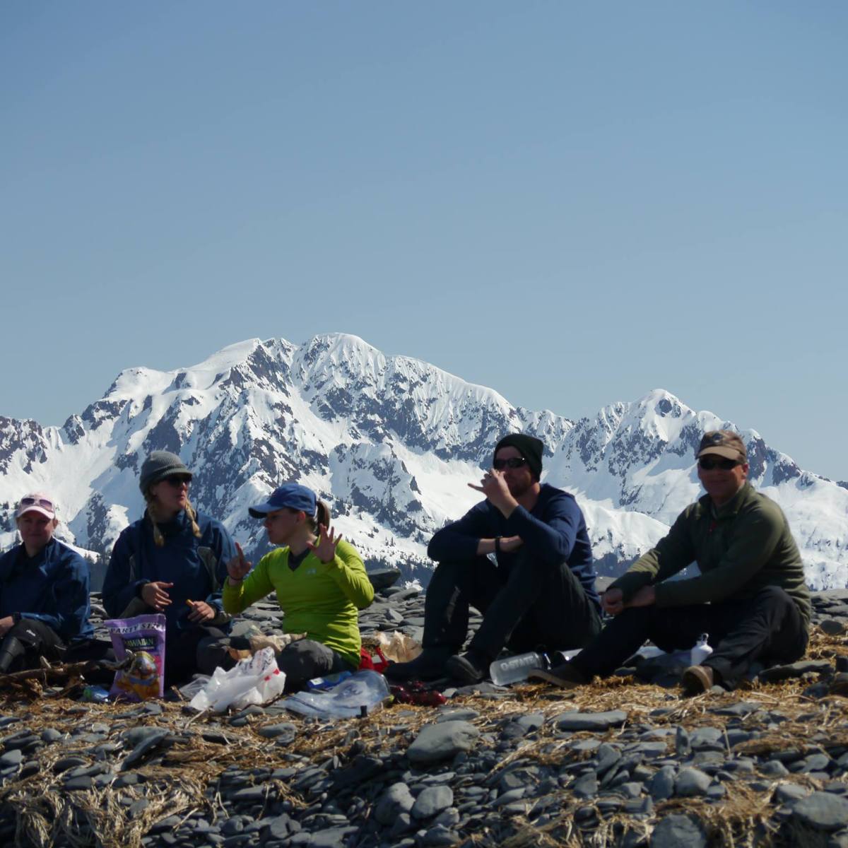 a group of people sitting on a rock