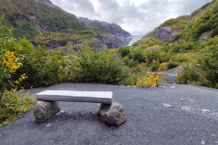 a stone bench sitting on top of a mountain