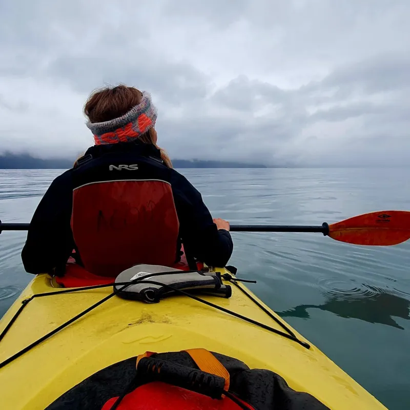 a person sitting in a boat on a body of water