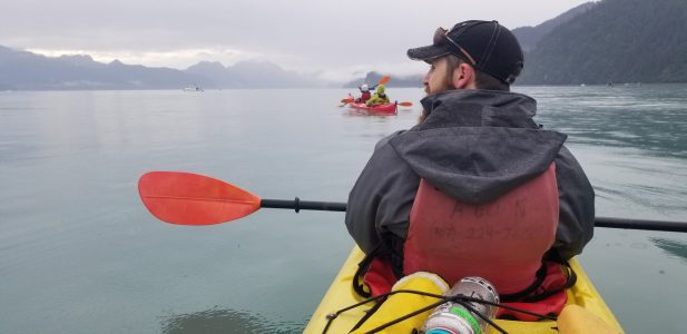 a man sitting in a boat on a body of water