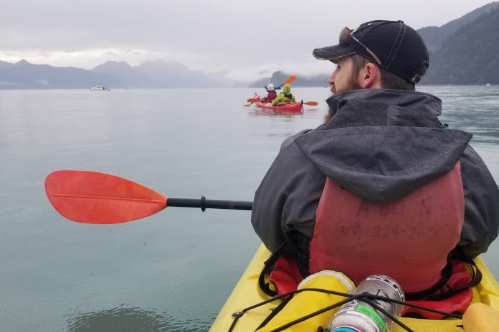 a man sitting in a boat on a body of water