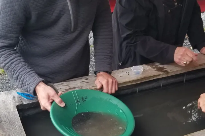 a group of people sitting at a picnic table
