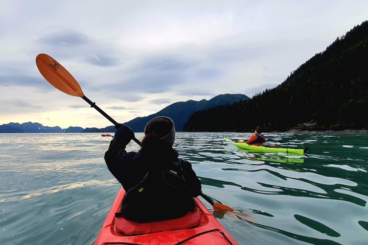 a person standing next to a body of water