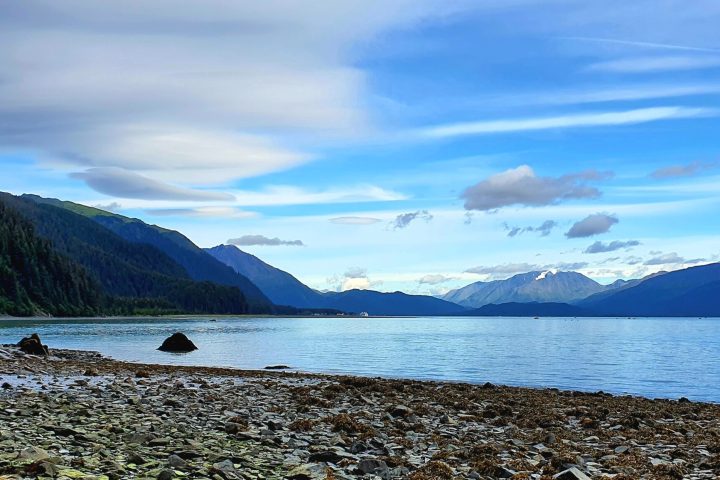 a rocky beach next to a body of water