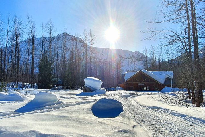 a man flying through the air on a snow covered slope