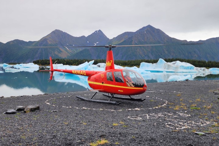 a small boat in a body of water with a mountain in the background