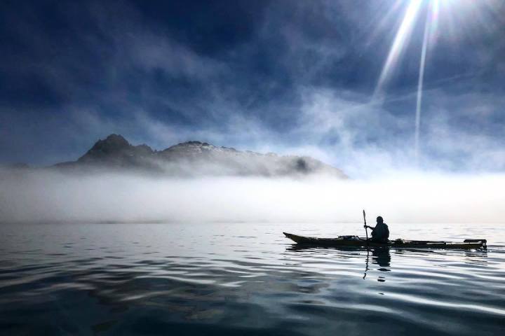 a group of clouds in the sky over a body of water