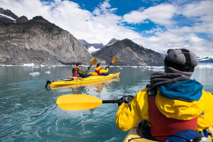 Group of friends enjoy ocean kayaking bear glacier during their