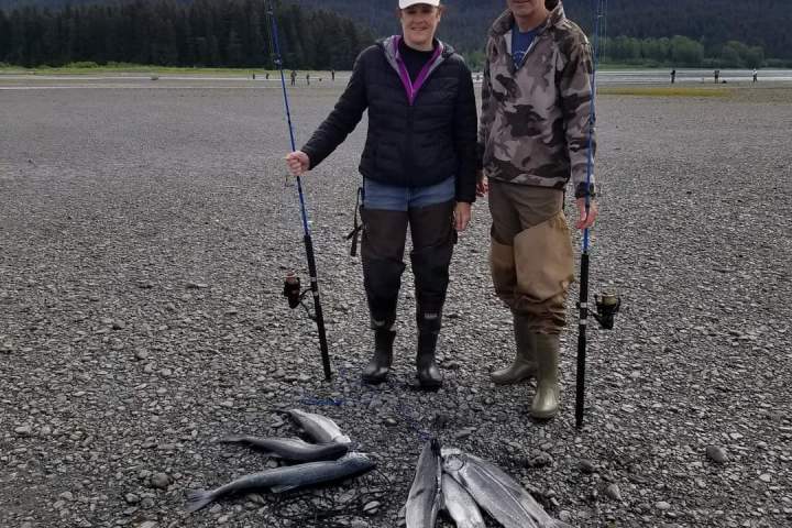 a man and a woman standing in front of a mountain