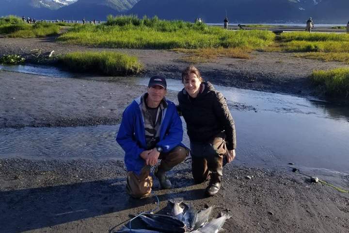 a man standing next to a body of water