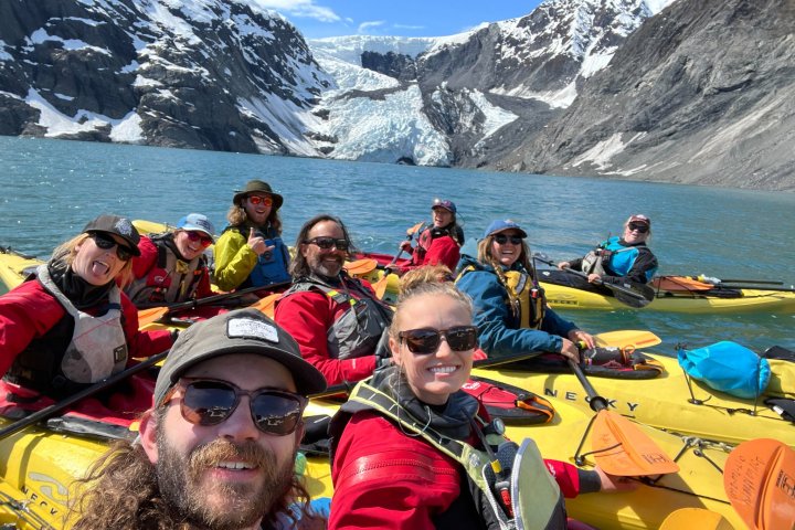 a group of people riding skis on a snowy mountain