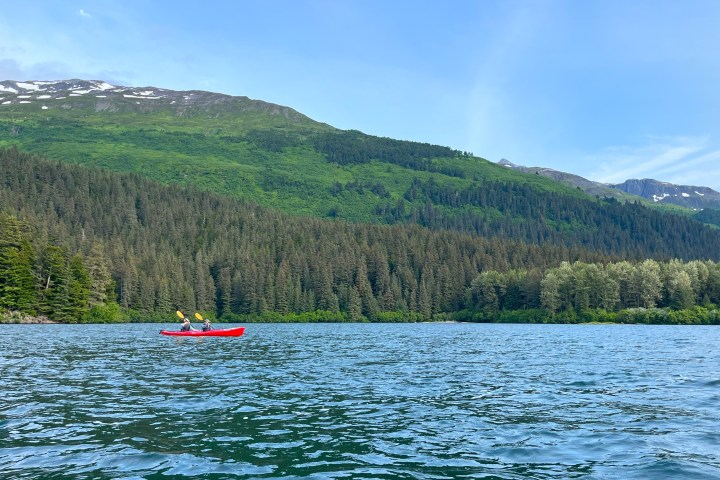 a body of water with a mountain in the background