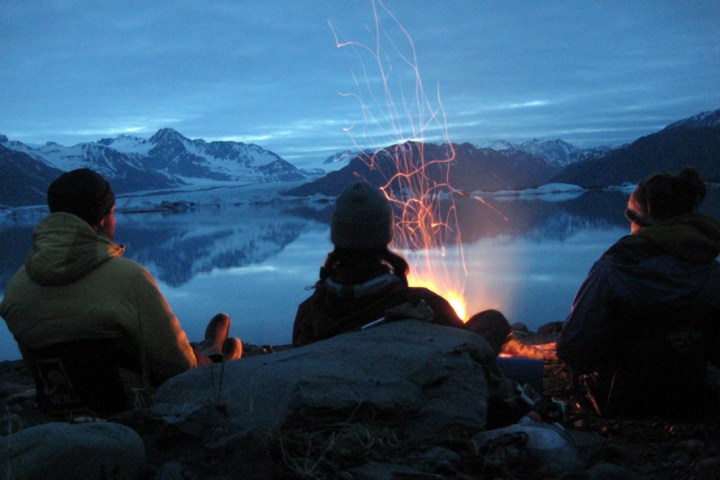 a group of people sitting in the snow