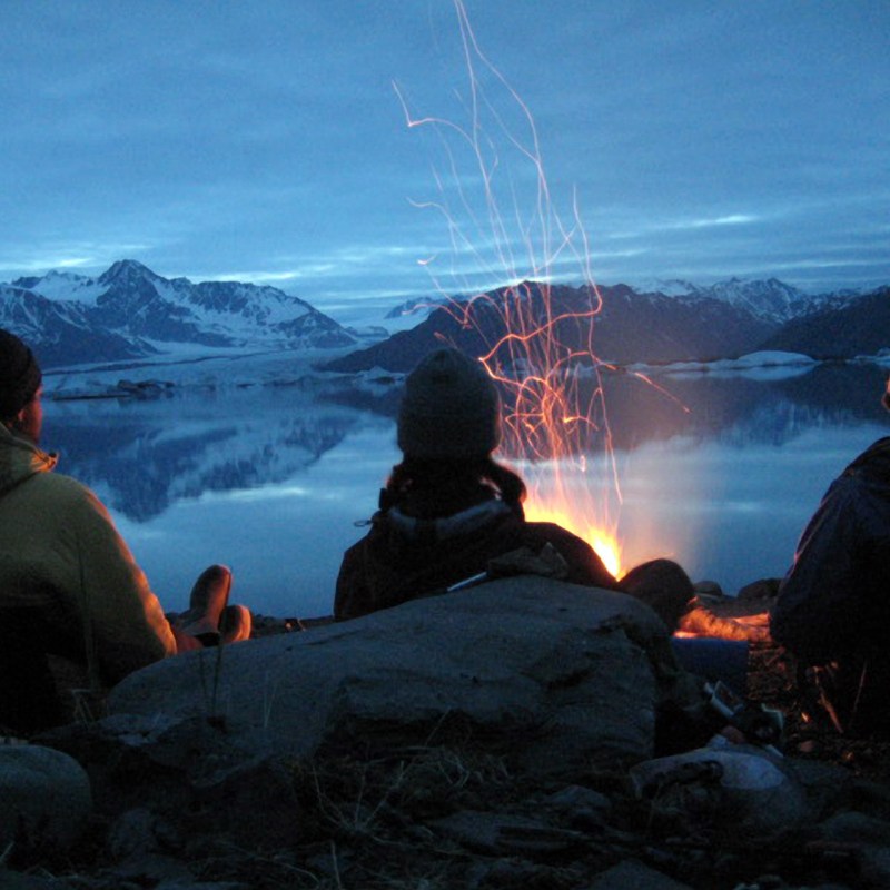 a group of people sitting in the snow