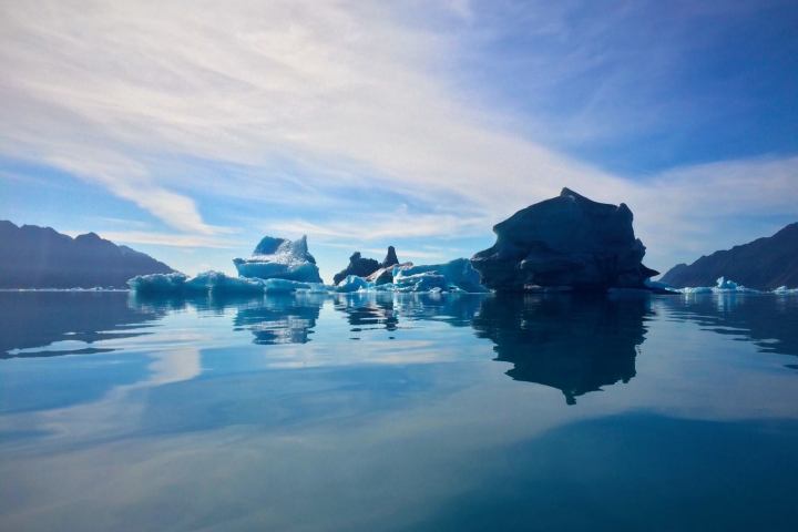 a group of clouds in the sky over a body of water