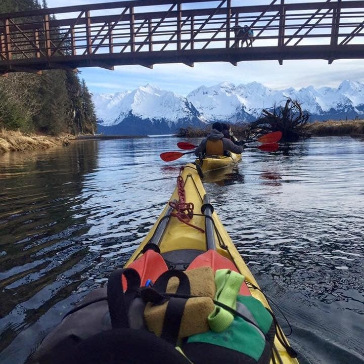 a train crossing a bridge over a body of water