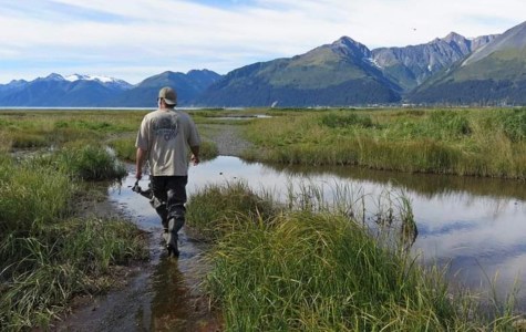 a man standing in front of a lake