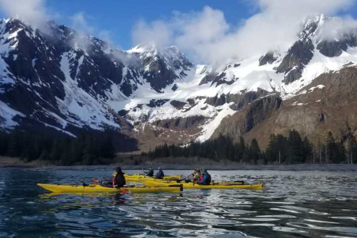 a group of people riding skis on a snowy mountain