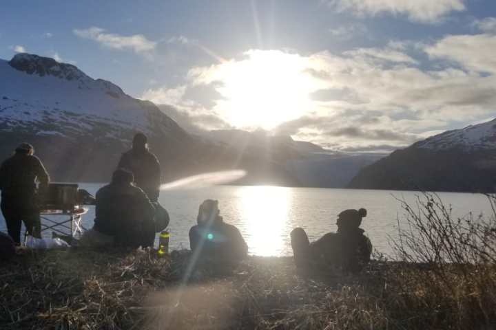 a group of people standing on top of a snow covered mountain