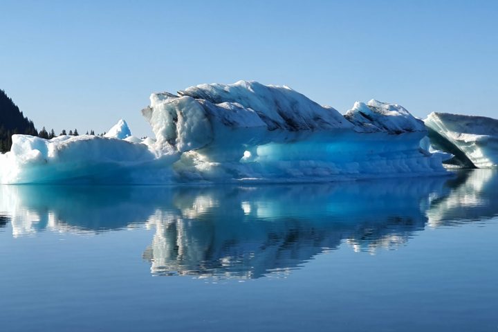 a body of water with a mountain in the snow