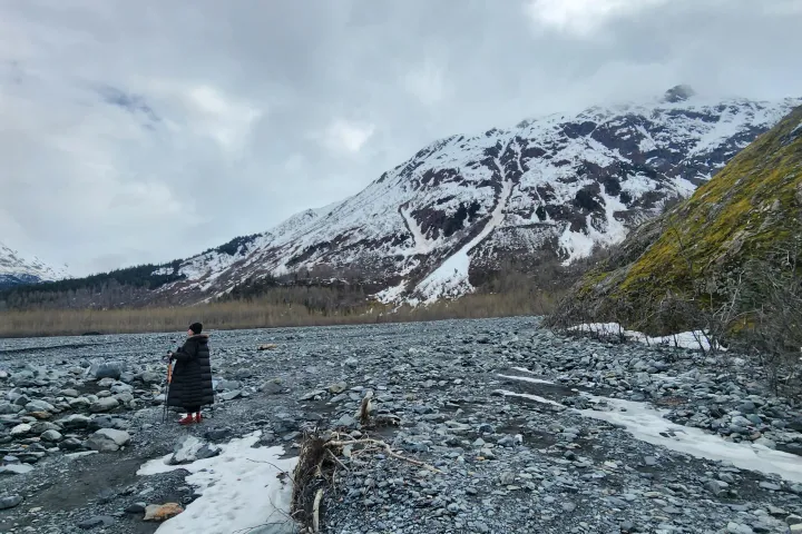 a man walking across a snow covered mountain