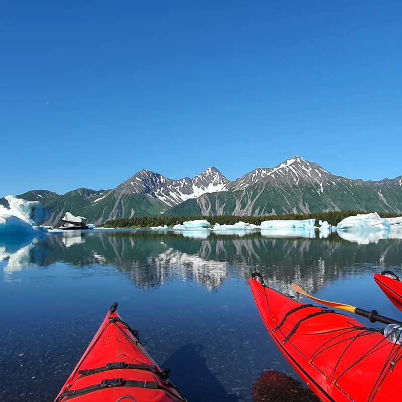 a large body of water with a mountain in the snow