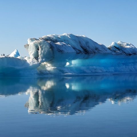 a body of water with a mountain in the snow