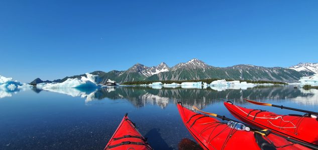 a body of water with a mountain in the snow