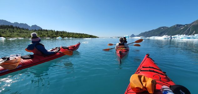 a group of people in a small boat in a body of water