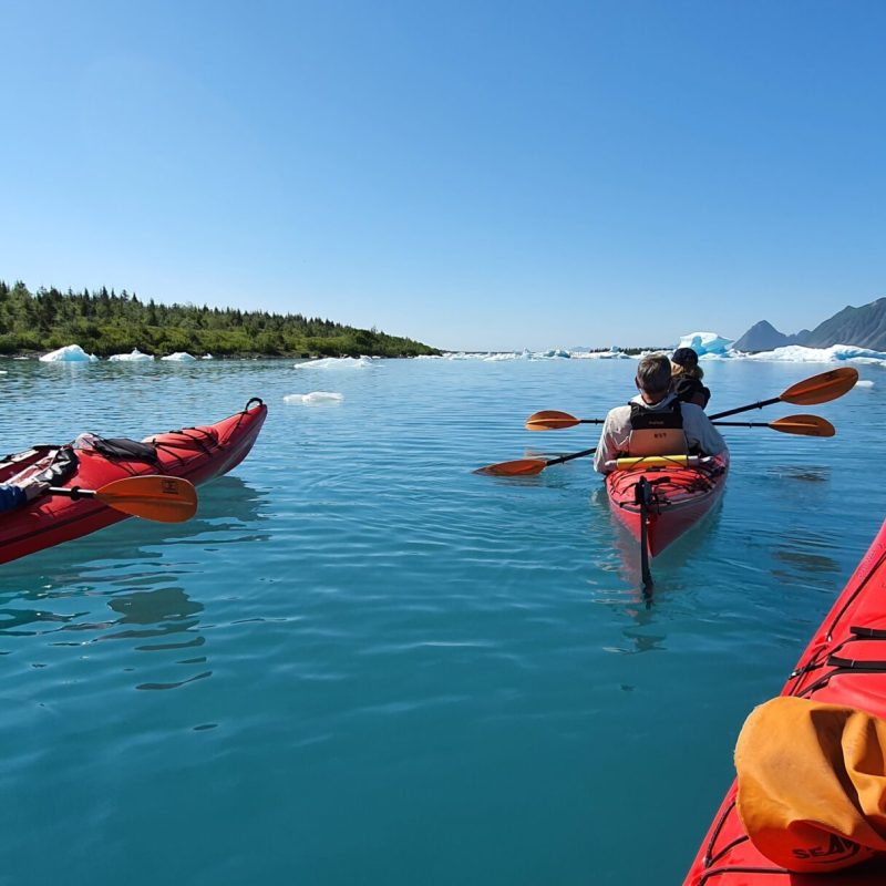 a group of people in a small boat in a body of water