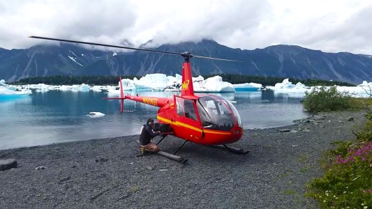 a small boat in a body of water with a mountain in the background