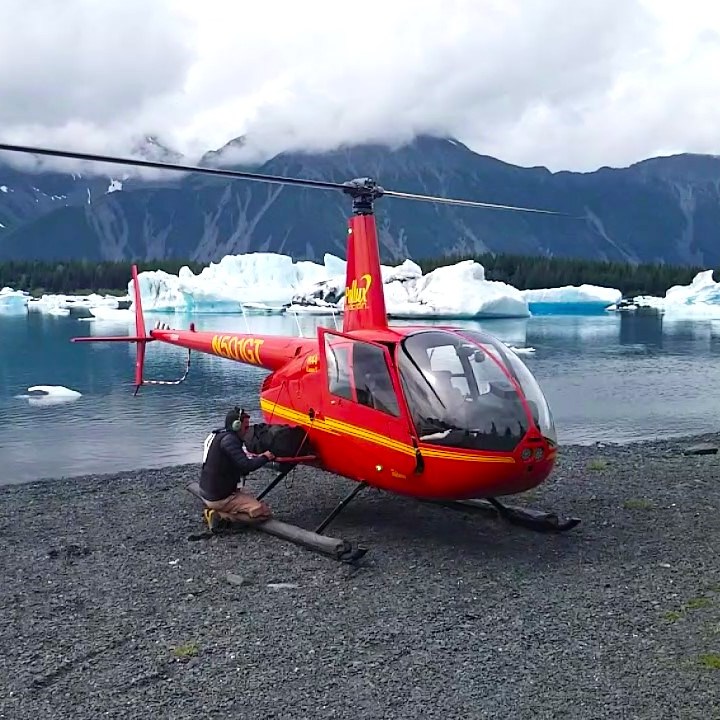 a small boat in a body of water with a mountain in the background