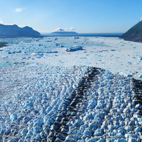 a large body of water with a mountain in the background