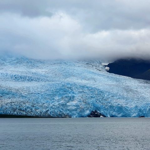 a body of water with a mountain in the background