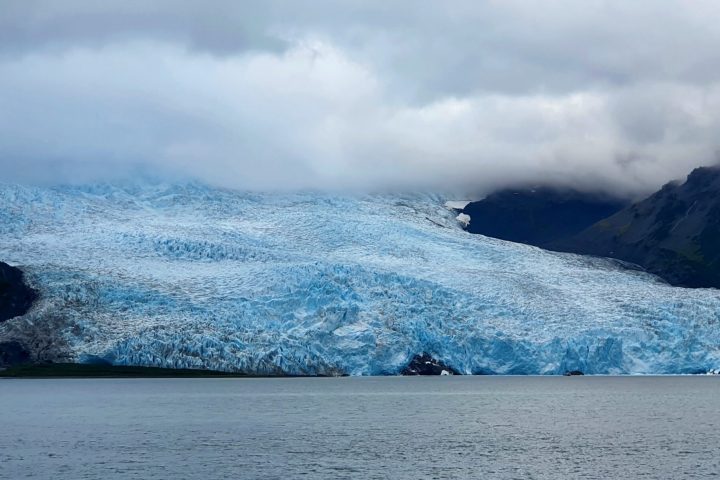 a body of water with a mountain in the background