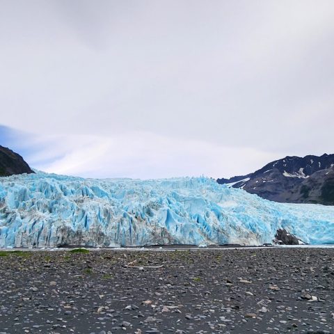 a body of water with a mountain in the background