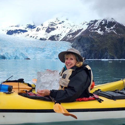 a young boy sitting on a boat in the water