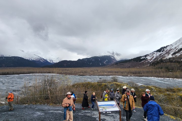 a group of people standing on top of a mountain