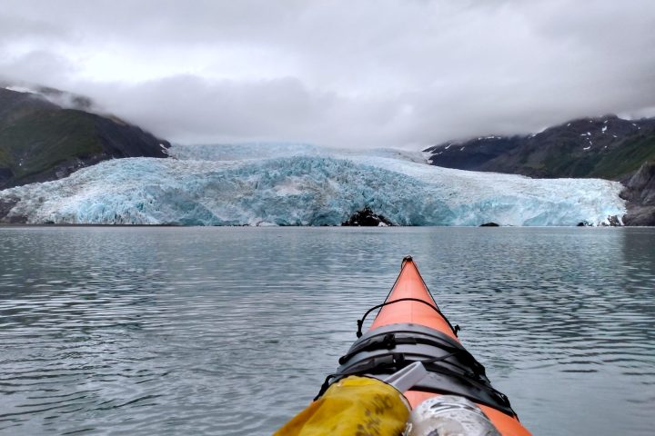 a person sitting in a boat on a body of water